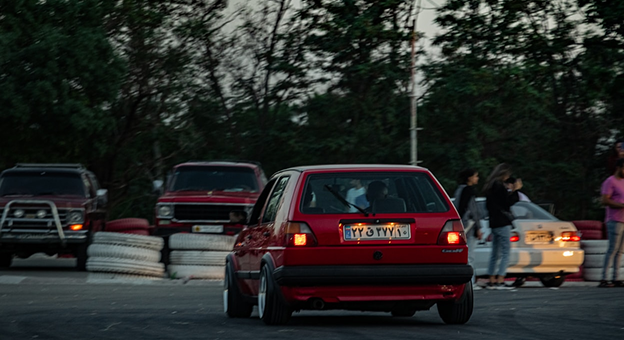 Red VW Golf drifting